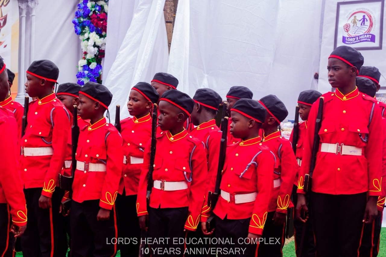 Lord’s Heart pupils in red ceremonial uniforms at an anniversary event